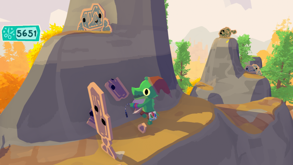 A screen shot from the Lil Gator game, featuring the titular character, a small gator wearing a hat, traversing mountains and hitting cardboard enemeies. 