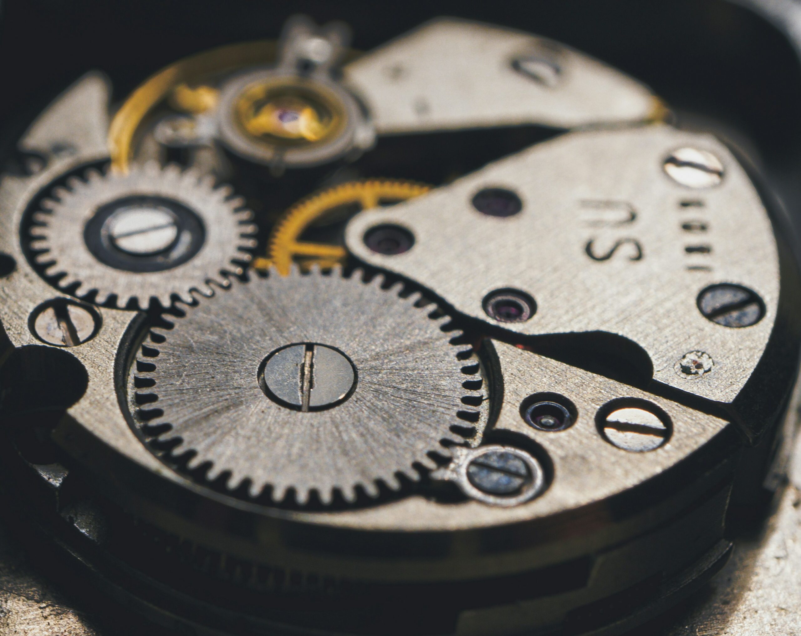 A photo of clockwork from inside a watch or clock.